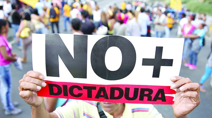 Opposition supporters holding a placard that reads,